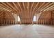 Large unfinished attic space with exposed wooden beams and minimal natural light at 2000 Stockton Walk Ln, Snellville, GA 30078