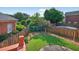 Scenic backyard featuring a well-maintained lawn, privacy fence, and mature trees, offering a serene outdoor space at 2000 Stockton Walk Ln, Snellville, GA 30078