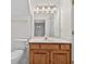 Bathroom with wooden cabinets, a white countertop, and a decorative light fixture at 2000 Stockton Walk Ln, Snellville, GA 30078