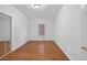 Bedroom features hardwood floors, a window, and a mirrored closet at 2000 Stockton Walk Ln, Snellville, GA 30078