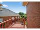 View of the wooden deck showcasing its access to the home's exterior and overlooking the lush backyard at 2000 Stockton Walk Ln, Snellville, GA 30078