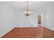 Bright dining room features hardwood floors, a chandelier, and an open entryway to the kitchen at 2000 Stockton Walk Ln, Snellville, GA 30078