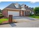 Beautiful brick home featuring an attached two-car garage and meticulously maintained landscaping at 2000 Stockton Walk Ln, Snellville, GA 30078
