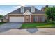 Charming brick home featuring a two-car garage, well-manicured lawn, and an inviting front entrance at 2000 Stockton Walk Ln, Snellville, GA 30078