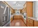 Kitchen with stainless steel refrigerator and lots of wooden cabinetry at 2000 Stockton Walk Ln, Snellville, GA 30078
