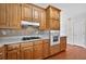 Kitchen featuring wooden cabinets, countertop, stove, oven and tile backsplash at 2000 Stockton Walk Ln, Snellville, GA 30078