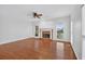 Bright living room featuring gleaming hardwood floors, a cozy fireplace, and natural light from the windows at 2000 Stockton Walk Ln, Snellville, GA 30078