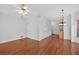 Open living room featuring hardwood floors, ceiling fan, and view into the breakfast nook at 2000 Stockton Walk Ln, Snellville, GA 30078