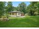 A well-maintained backyard boasts a generous lawn and patio area surrounded by mature trees at 4291 Lamar Street St, Decatur, GA 30035