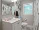 Clean bathroom featuring a white vanity, toilet, shower with curtain, and a window at 4291 Lamar Street St, Decatur, GA 30035