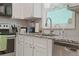 Close-up of the kitchen sink, faucet, granite counters, and cabinets at 4291 Lamar Street St, Decatur, GA 30035