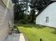 Backyard view showcasing manicured lawn, surrounded by lush trees and another property at 8113 Fieldstream Way, Douglasville, GA 30134