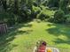 View of lush green backyard with greenery, plants and grass at 8113 Fieldstream Way, Douglasville, GA 30134