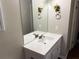 Bathroom features a white vanity with a large mirror and decorative flower art at 8113 Fieldstream Way, Douglasville, GA 30134