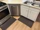 The kitchen boasts stainless steel appliances and a double basin sink with light colored cabinets at 8113 Fieldstream Way, Douglasville, GA 30134