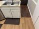 A view of the kitchen sink with double basin and white cabinets on light floors at 8113 Fieldstream Way, Douglasville, GA 30134