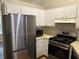 Modern kitchen with stainless steel appliances, white cabinetry, and stylish backsplash at 8113 Fieldstream Way, Douglasville, GA 30134