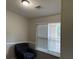 Bright living room with large window with blinds, neutral paint, and arm chair at 8113 Fieldstream Way, Douglasville, GA 30134