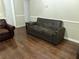 Living room area with hardwood floors, neutral paint, and a gray sofa at 8113 Fieldstream Way, Douglasville, GA 30134