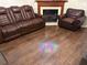 A living room area with hardwood floors and a fireplace with a wood mantle and trim at 8113 Fieldstream Way, Douglasville, GA 30134
