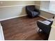 Cozy living room featuring dark wood floors, neutral walls, and comfortable seating at 8113 Fieldstream Way, Douglasville, GA 30134