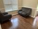Inviting living room featuring modern furniture, dark wood flooring, and ample natural light at 8113 Fieldstream Way, Douglasville, GA 30134