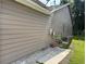 Side exterior view showing utilities hook ups, concrete area with grass and fenced yard at 8113 Fieldstream Way, Douglasville, GA 30134