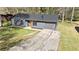 Front exterior featuring a single car garage, new siding, and green lawn at 8212 Englewood Trl, Riverdale, GA 30274
