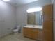 Well-lit bathroom with a light wood vanity, a large mirror, and a beige tile floor at 870 Mayson Turner Nw Rd # 1344, Atlanta, GA 30314