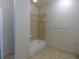 Bright bathroom featuring a white tub with a tile surround and a tiled floor at 870 Mayson Turner Nw Rd # 1344, Atlanta, GA 30314