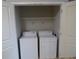 A closet containing side-by-side washer and dryer units with a shelf above at 870 Mayson Turner Nw Rd # 1344, Atlanta, GA 30314