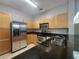 Galley kitchen featuring stainless steel appliances, dark countertops, and ample cabinet space at 870 Mayson Turner Nw Rd # 1228, Atlanta, GA 30314
