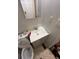 Small bathroom featuring a pedestal sink, toilet, and a wall-mounted mirror at 1566 Avon Sw Ave, Atlanta, GA 30311