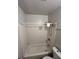 Bathroom with white tiled shower and standard fixtures and toilet at 1566 Avon Sw Ave, Atlanta, GA 30311