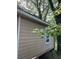 Exterior view of home showing tan siding and a white framed window at 1566 Avon Sw Ave, Atlanta, GA 30311