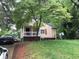 Charming single-Gathering home with a cozy front porch and mature tree at 1566 Avon Sw Ave, Atlanta, GA 30311
