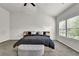 Bright bedroom features a ceiling fan, plush carpet, and large windows overlooking the landscaped yard at 2638 Village Park Bnd, Duluth, GA 30096