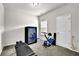 Bedroom with neutral walls, carpeted floor, window with blinds and workout equipment at 2638 Village Park Bnd, Duluth, GA 30096