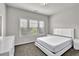 Bedroom with neutral walls, carpet, triple windows, and modern white furnishings at 2638 Village Park Bnd, Duluth, GA 30096