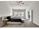 Bright bedroom features a ceiling fan, plush carpet, and large windows overlooking the landscaped yard at 2638 Village Park Bnd, Duluth, GA 30096