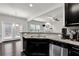 Bright kitchen with granite counters, stainless steel appliances, and an open view to the living area at 2638 Village Park Bnd, Duluth, GA 30096