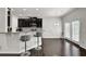 Modern kitchen featuring a breakfast bar with seating, dark cabinets, and stainless steel appliances at 2638 Village Park Bnd, Duluth, GA 30096