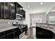 Modern kitchen with stainless steel appliances, granite countertops, and dark wood cabinets at 2638 Village Park Bnd, Duluth, GA 30096