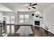 Bright living room featuring a fireplace, ceiling fan, and large windows at 2638 Village Park Bnd, Duluth, GA 30096