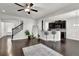 Hardwood floors with a partial kitchen and bar seating, stairs, and a fireplace at 2638 Village Park Bnd, Duluth, GA 30096