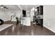 Open-concept living room with dark hardwood floors and a view of the modern kitchen at 2638 Village Park Bnd, Duluth, GA 30096