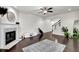 Well-lit living room featuring hardwood flooring, fireplace, and staircase at 2638 Village Park Bnd, Duluth, GA 30096