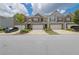 Charming townhomes with brick accents, attached garages, and well-maintained landscaping on a sunny day at 2638 Village Park Bnd, Duluth, GA 30096