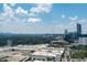 Expansive aerial view featuring a cityscape, shopping mall, and verdant tree canopy at 3475 Oak Valley Ne Rd # 910, Atlanta, GA 30326