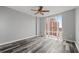 Bright bedroom features large window, ceiling fan, and wood-look floors at 3475 Oak Valley Ne Rd # 910, Atlanta, GA 30326